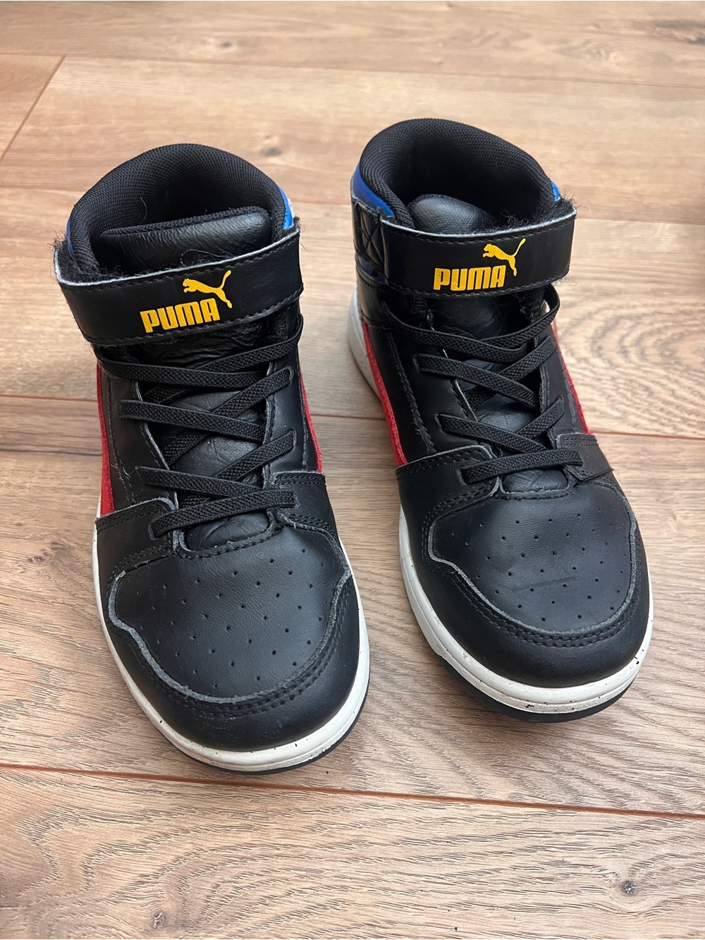 Puma Kids Black Sneakers with Red Accents and Yellow Logo